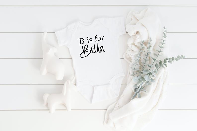 Baby name reveal idea- baby name bodysuit- personalized baby bodysuit - maternity picture idea- newborn baby shower gift basket idea